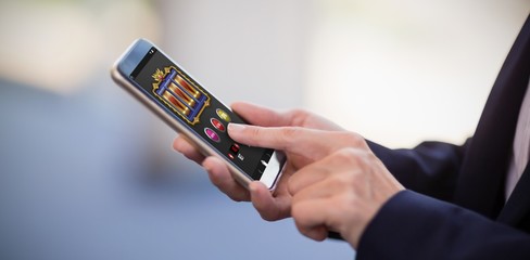 Composite image of slot machine app on mobile display