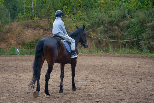 Teen Learning To Ride A Horse