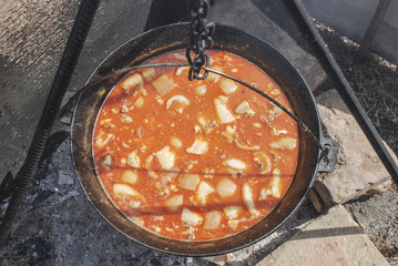 Cooking bean in a caldron on open flame