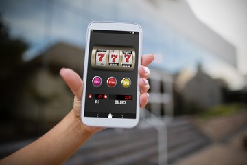 Composite image of casino slot machine app on mobile display