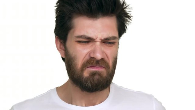 Caucasian man smelling stinky crinkle face on white background