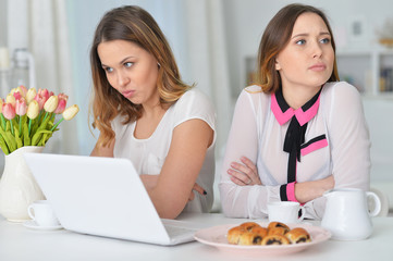 two female friends after quarrel 