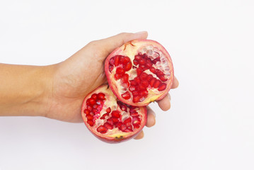 Hand Holding Pomegranate Fruit Cut Into Half Over White Background