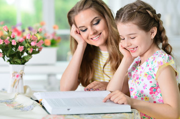 mother and daughter reading 