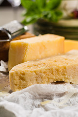 Aged parmesan cheese on the olive wooden board