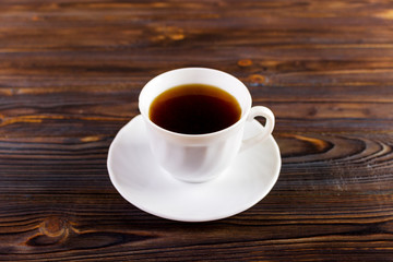 cup of coffee on wooden background add copy space for text
