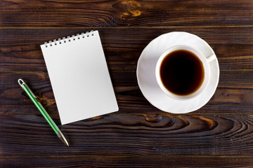 Blank paper and coffee cup on wood table