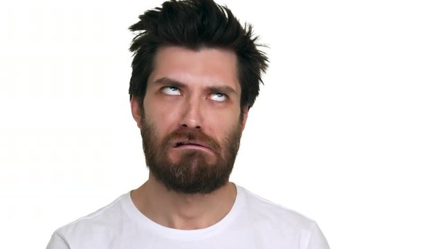 Caucasian man making foolish faces on white background