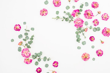 Obraz premium Frame made of pink roses and eucalyptus on white background. Flat lay, top view