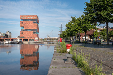 Contextual view on the MAS museum reflected in a dock (Willemdok) in Antwerp,  Belgium.