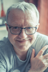 Vertical portrait of happy man with glasses