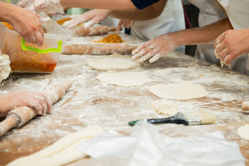 Obraz na płótnie Canvas Manufacture of dough products. Hands closeup