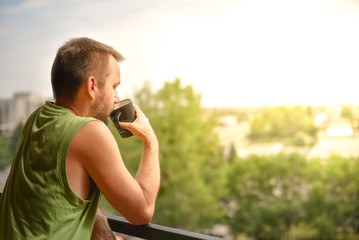 Man having coffee on a balcony