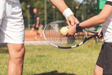 Trainer teaching boy how to hold racket © Yakobchuk Olena