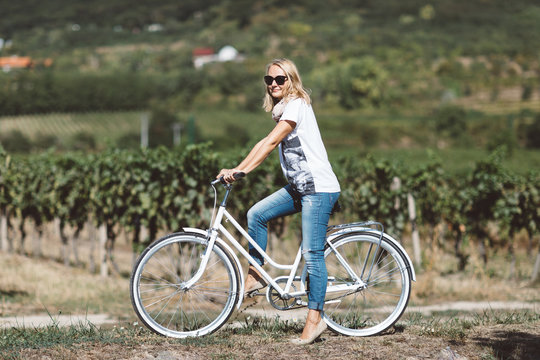 Woman on white, restored, retro bicycle