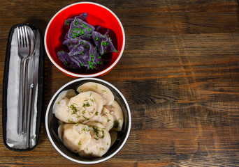dumplings - pelmeni, ravioli with meat and fish on a wooden background with copy space. top view.