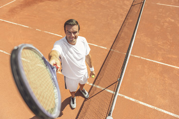 Happy smiling man playing tennis