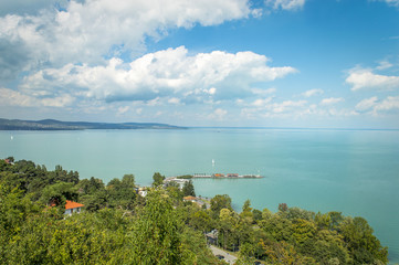 Fototapeta na wymiar Beautiful view of Lake Balaton, from Tihany village in Hungary, with blue sky and clouds, summer colors in the foreground