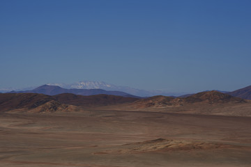Fototapeta na wymiar Arid landscape alongside the Pan American Highway (Ruta 5) running through the Atacama in northern Chile.