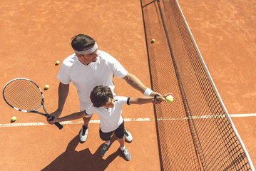 Family learning to play tennis