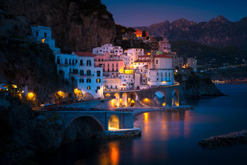 Night view of Amalfi cityscape on coast line of mediterranean sea, Italy - Powered by Adobe