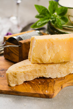 Aged parmesan cheese on the olive wooden board