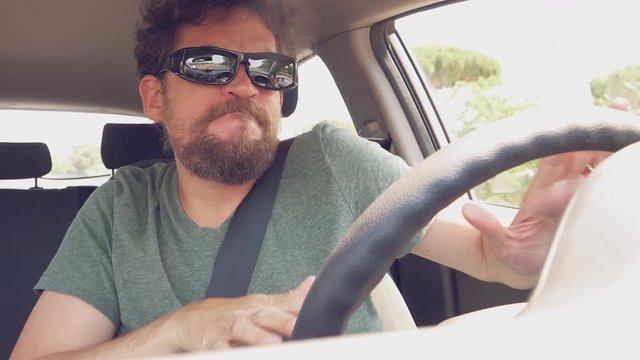 Funny man dancing like crazy driving car moving hair slow motion