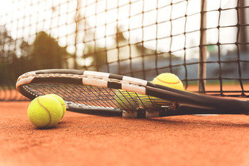 Necessary tennis equipment near net - obrazy, fototapety, plakaty