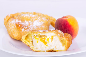 two samosas with cottage cheese and peach filling