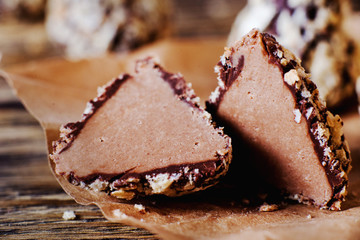 Sweets and desserts, round chocolate sweets with nut cream filling , macro