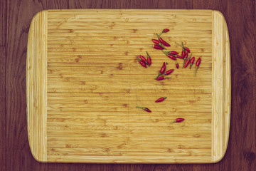 wooden kitchen cutting board with hot peppers
