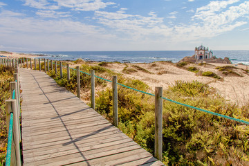 Fototapeta na wymiar Vista da Capela da Senhora da Pedra na Praia de Miramar em Gaia Portugal