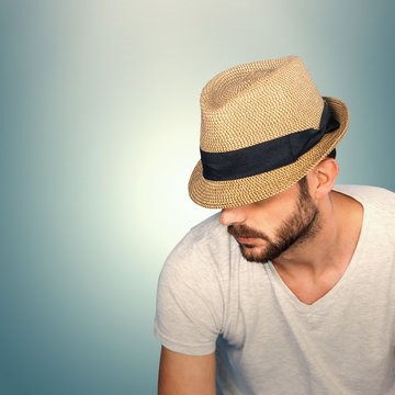 Composite image of handsome man wearing hat 