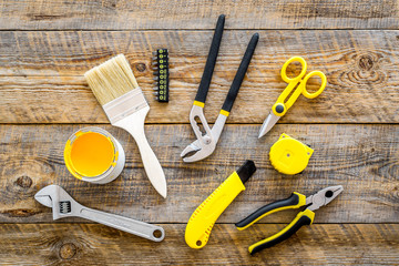 constructor desk with set of building implements and brushes wooden desk background top view