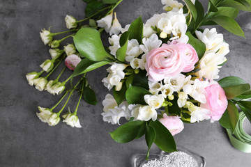 Fototapeta na wymiar Composition with beautiful freesia flowers on gray background