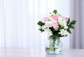 Beautiful bouquet with white freesia on table