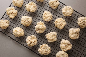 Baking grid with raw dough for cookies on kitchen table