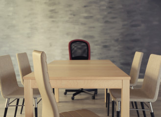 Empty wooden table and chairs in conference room