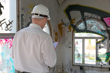 Insurance adjuster inspecting abandoned building