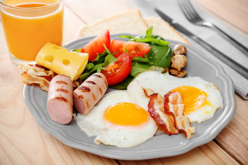 Tasty breakfast with eggs on plate