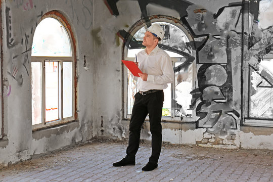 Insurance adjuster inspecting abandoned building