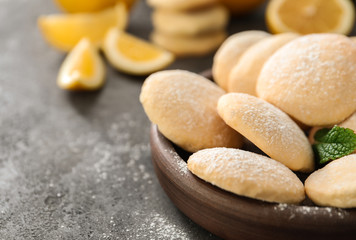 Plate with homemade lemon cookies on table