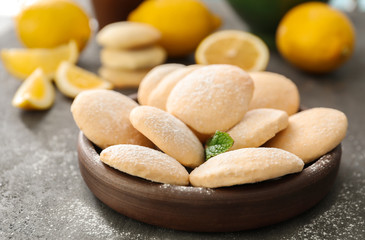 Plate with homemade lemon cookies on table