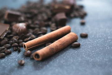 Sweet still life. Coffee beans, chocolate bars and cinnamon sticks.