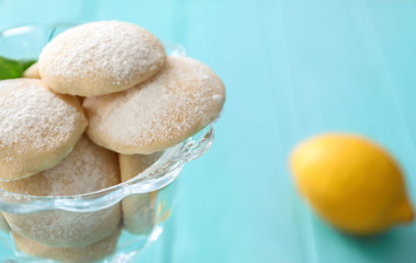 Glass bowl with homemade lemon cookies on table, closeup