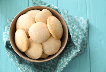 Bowl with homemade lemon cookies on wooden table