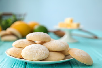 Plate with homemade lemon cookies on wooden table