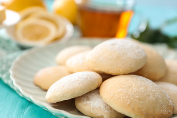 Plate with homemade lemon cookies on table, closeup