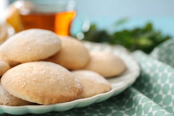 Plate with homemade lemon cookies on table, closeup