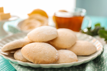 Plate with homemade lemon cookies on table, closeup
